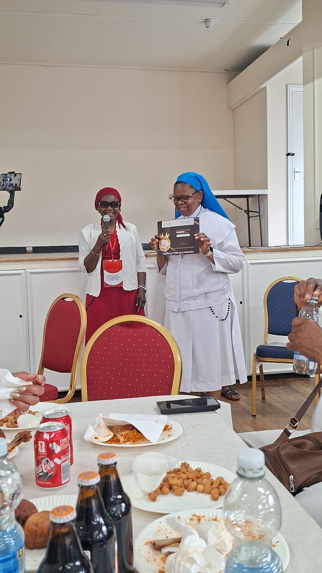 Sister holding a certificate at the Walthamstow consecration event